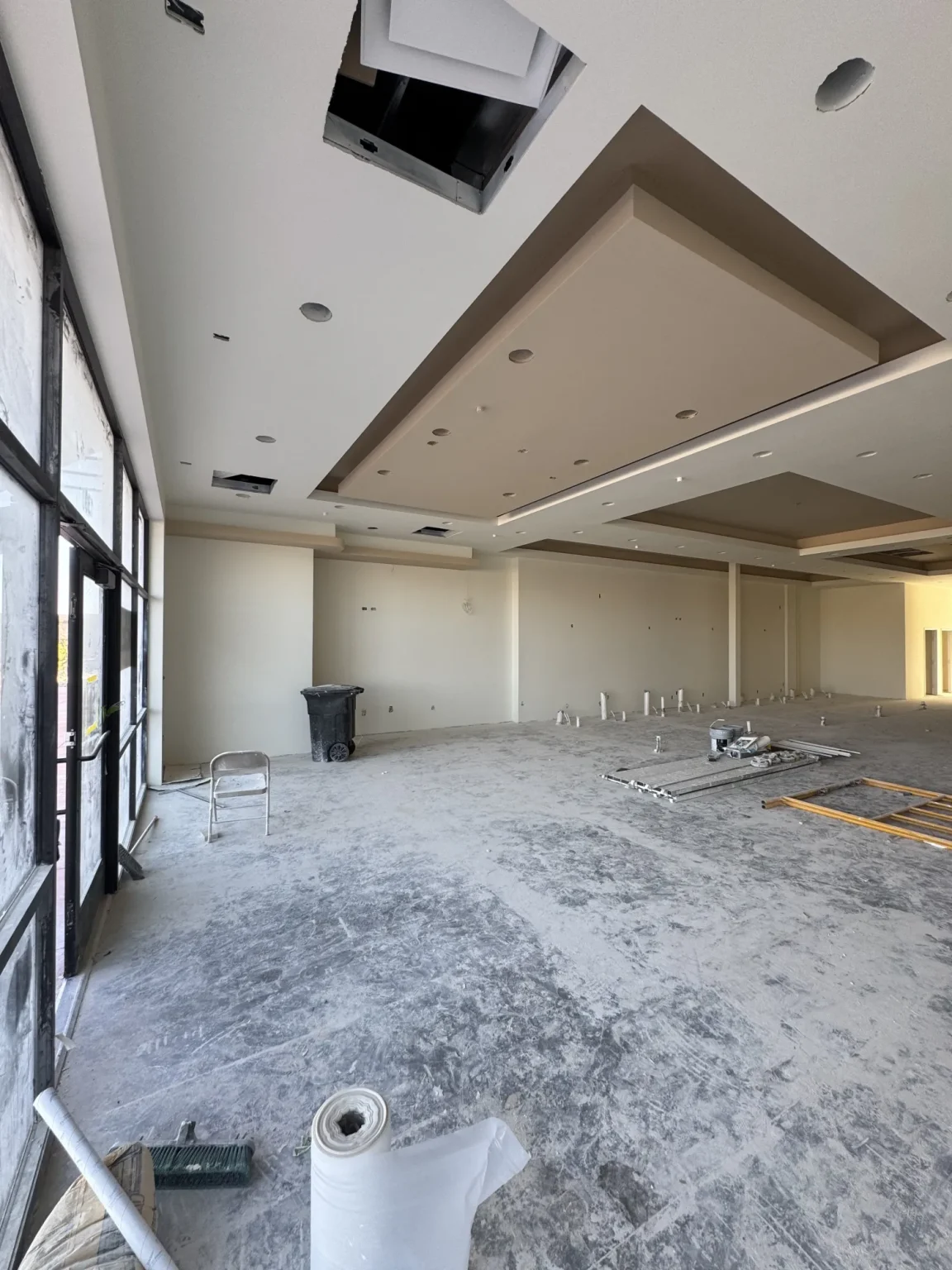 commercial-23 Interior of an unfinished commercial space with construction materials and debris on the floor.